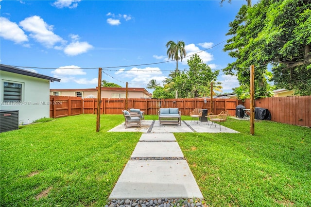 view of yard with a patio and central AC