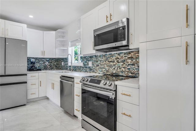 kitchen featuring backsplash, stainless steel appliances, white cabinetry, sink, and light tile patterned flooring