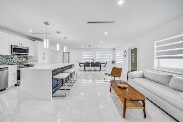 living room with plenty of natural light and light tile patterned flooring