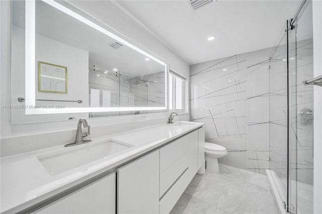 bathroom with tile patterned flooring, toilet, double vanity, and walk in shower