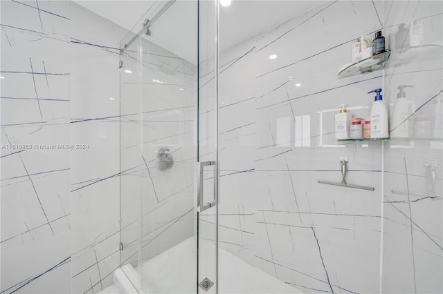 bathroom with a shower with shower door