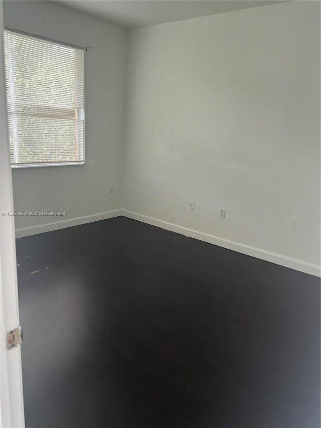 spare room with wood-type flooring