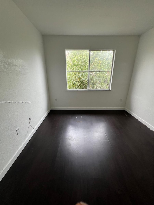 empty room with dark hardwood / wood-style floors