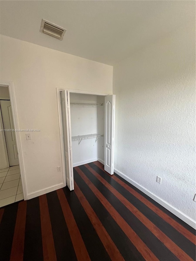 unfurnished bedroom with a closet