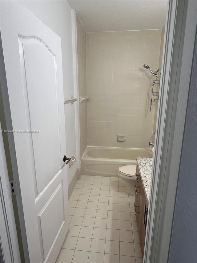 full bathroom with tile patterned floors, toilet, tiled shower / bath combo, and vanity