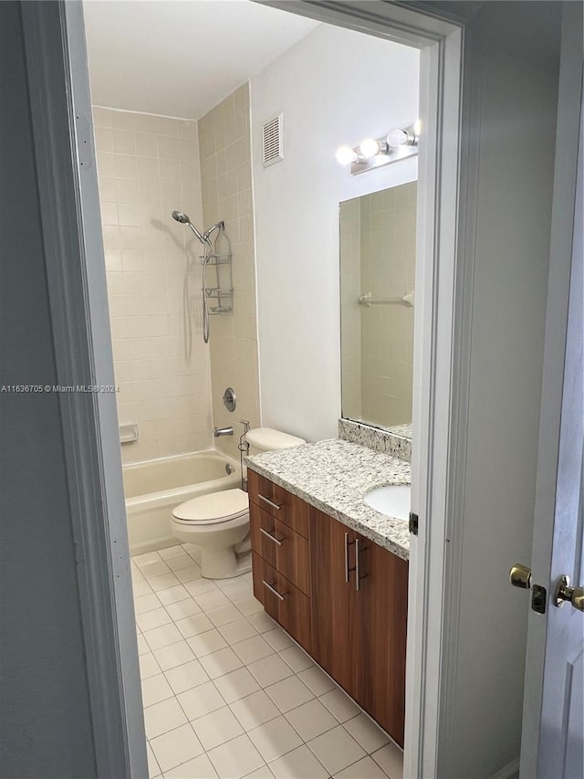 full bathroom with tile patterned flooring, vanity, toilet, and tiled shower / bath combo