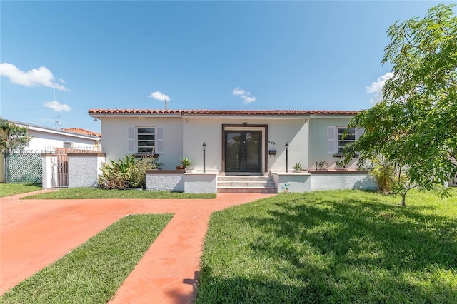 mediterranean / spanish-style house with a front lawn