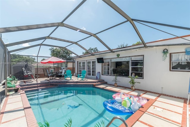 view of swimming pool with a lanai and a patio area