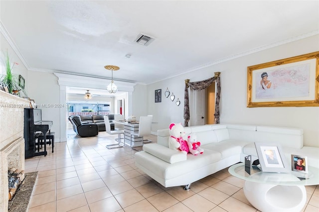 living room featuring light tile patterned floors, ceiling fan, and crown molding