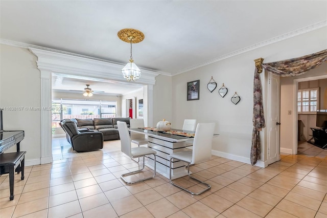 tiled dining area featuring ceiling fan and crown molding