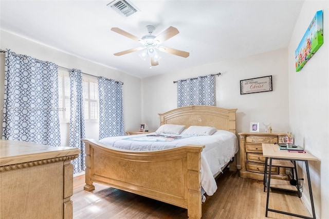 bedroom with hardwood / wood-style floors and ceiling fan