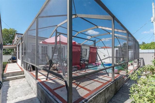 view of patio / terrace with a lanai and a swimming pool