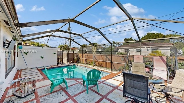 view of swimming pool with a patio and a lanai