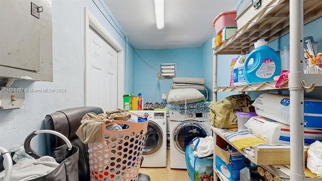 clothes washing area with washing machine and clothes dryer