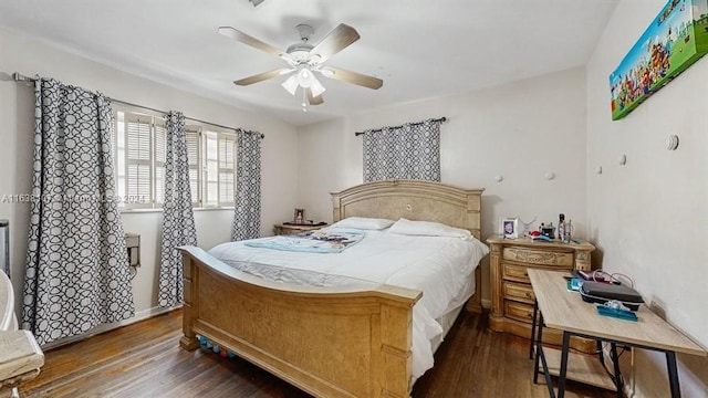 bedroom with dark hardwood / wood-style flooring and ceiling fan