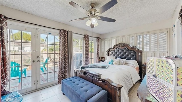 tiled bedroom with ceiling fan, access to exterior, a textured ceiling, and french doors