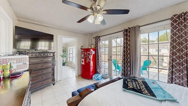 tiled bedroom with access to exterior, ceiling fan, french doors, and a textured ceiling