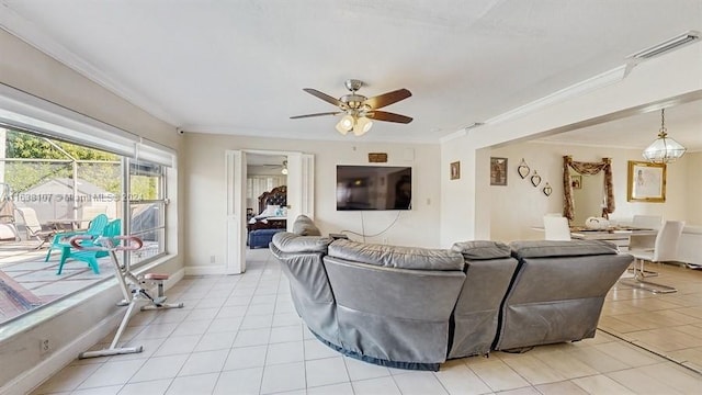 tiled living room with ceiling fan and crown molding