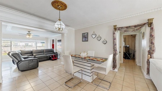 tiled dining area with crown molding and ceiling fan with notable chandelier