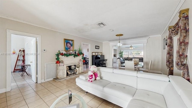 living room featuring light tile patterned floors, ceiling fan, and crown molding