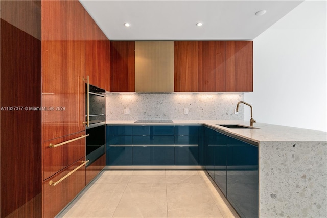 kitchen with sink, light stone counters, backsplash, and light tile patterned floors