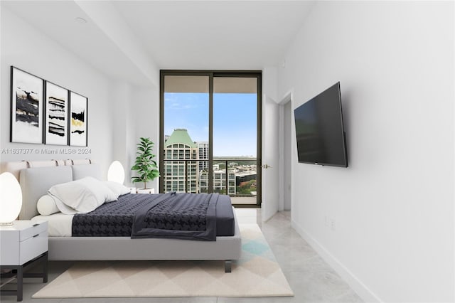 bedroom with floor to ceiling windows, access to outside, and light tile patterned floors