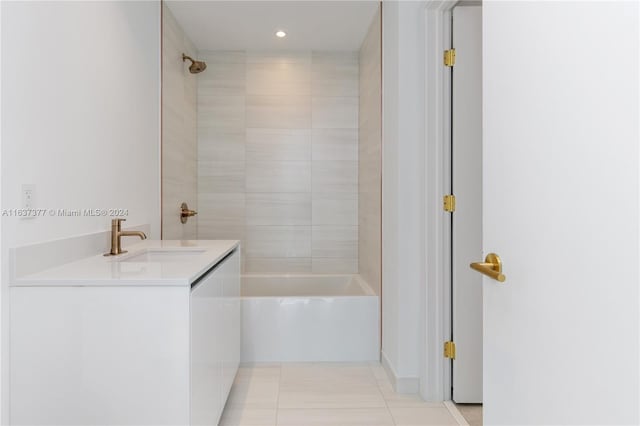 bathroom with vanity, tiled shower / bath, and tile patterned flooring