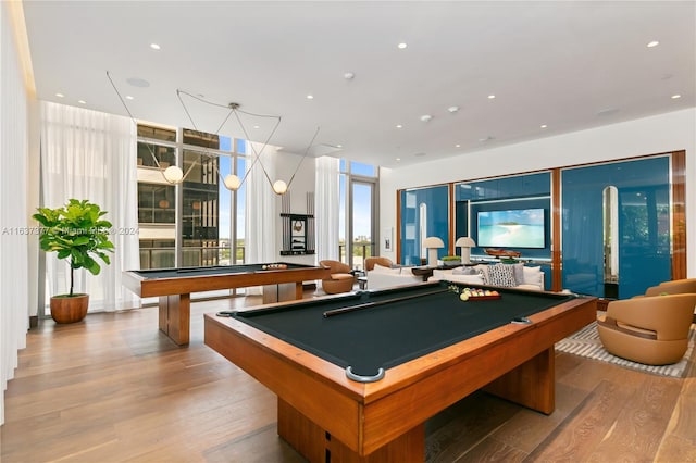 game room with light wood-type flooring, floor to ceiling windows, and pool table