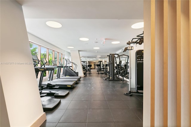 exercise room featuring dark tile patterned flooring