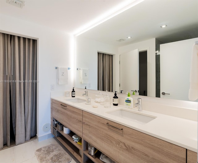 bathroom with dual vanity and tile patterned floors