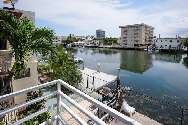 exterior space featuring a balcony and a water view