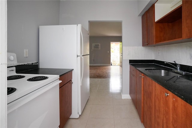 kitchen with dark stone countertops, light tile patterned floors, electric stove, decorative backsplash, and sink