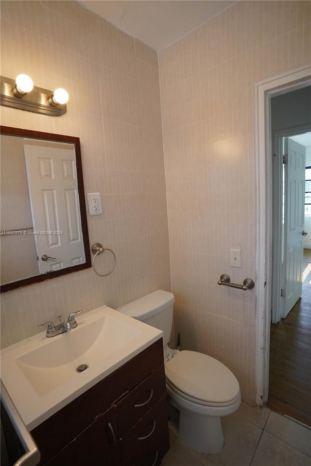 bathroom with vanity, tile walls, wood-type flooring, and toilet