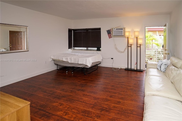 bedroom featuring a wall mounted AC and hardwood / wood-style floors