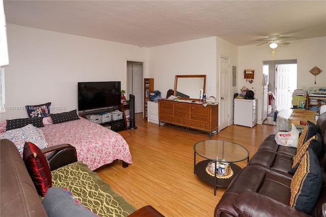 living room with electric panel, ceiling fan, and hardwood / wood-style floors