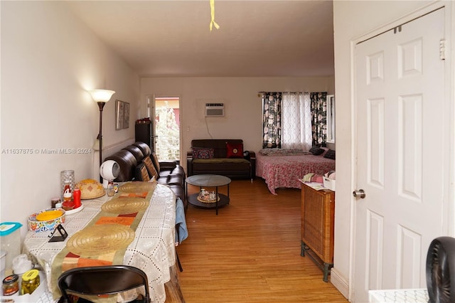 bedroom featuring an AC wall unit and hardwood / wood-style floors