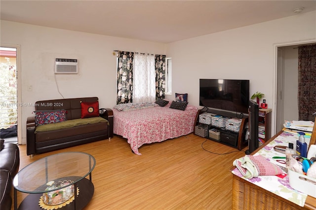 bedroom with light hardwood / wood-style flooring and multiple windows