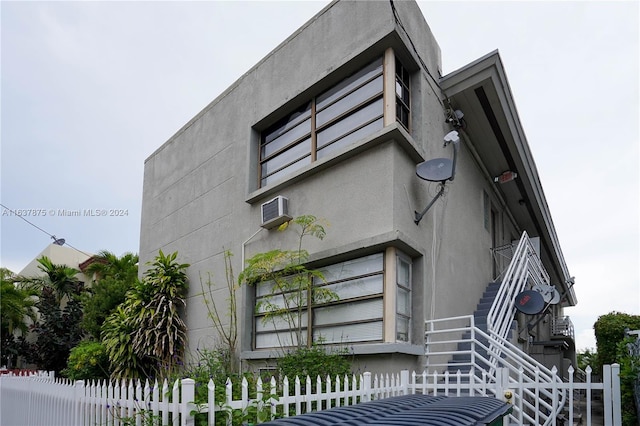 view of property exterior featuring a wall mounted AC