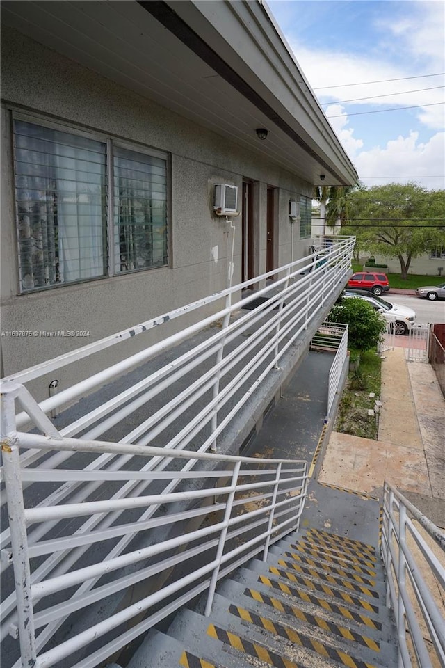 view of home's exterior with a wall mounted air conditioner