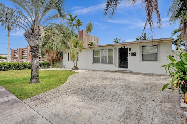 view of front facade with a patio area and a front lawn