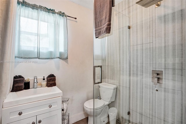 bathroom featuring vanity, an enclosed shower, and toilet