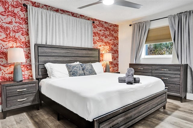 bedroom with ceiling fan and hardwood / wood-style flooring