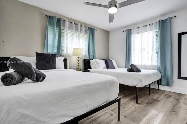 bedroom with light wood-type flooring and ceiling fan