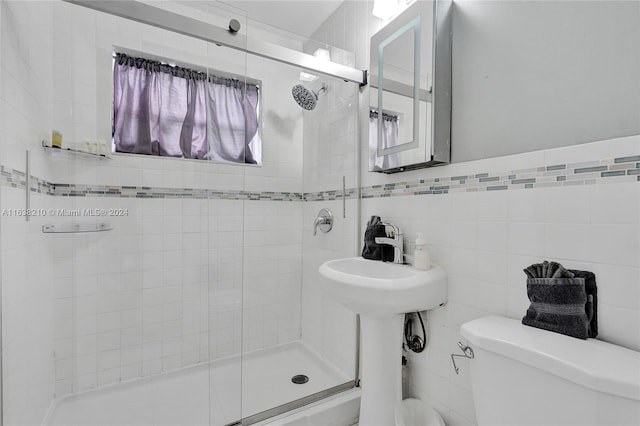 bathroom featuring tile walls and toilet