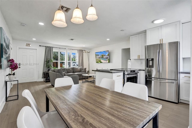 dining space featuring light hardwood / wood-style floors