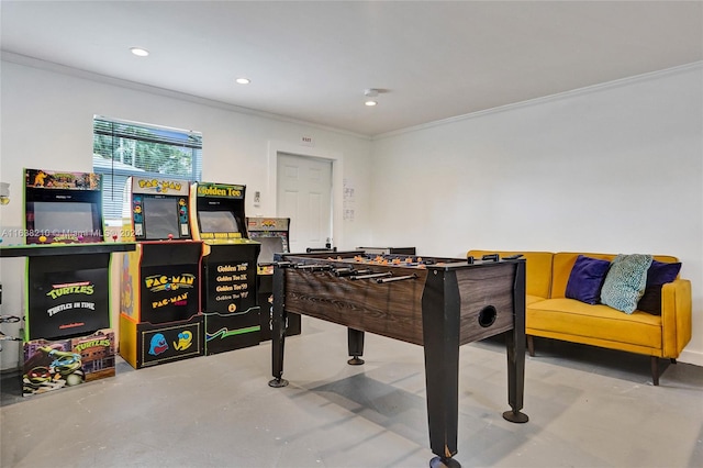 recreation room with ornamental molding and concrete flooring