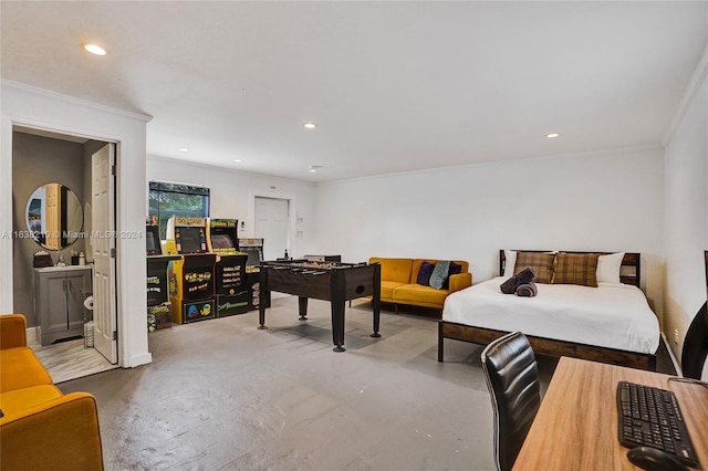 bedroom featuring concrete flooring, connected bathroom, and crown molding