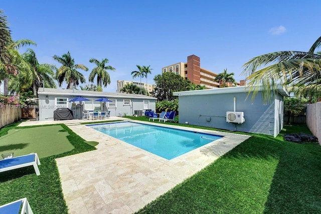 view of swimming pool with a yard and a patio area