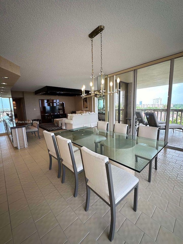 dining room featuring light tile patterned floors, plenty of natural light, expansive windows, and a notable chandelier