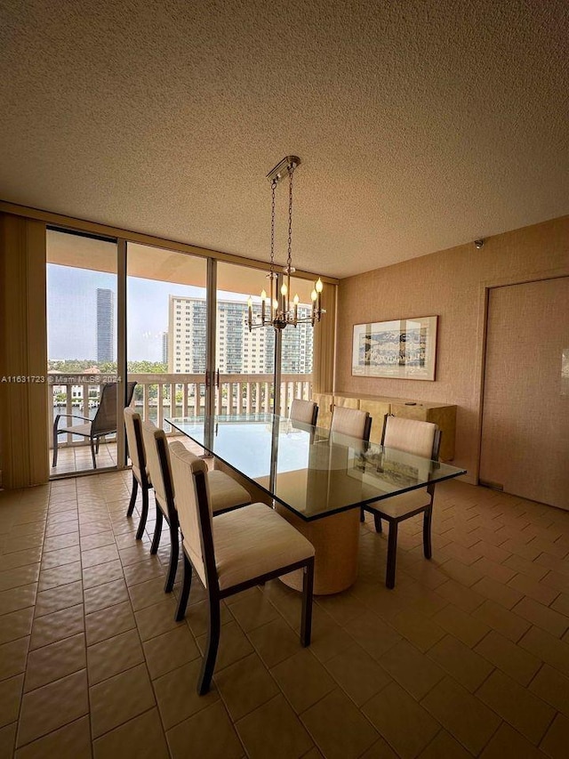 unfurnished dining area with a chandelier, expansive windows, a textured ceiling, and a city view